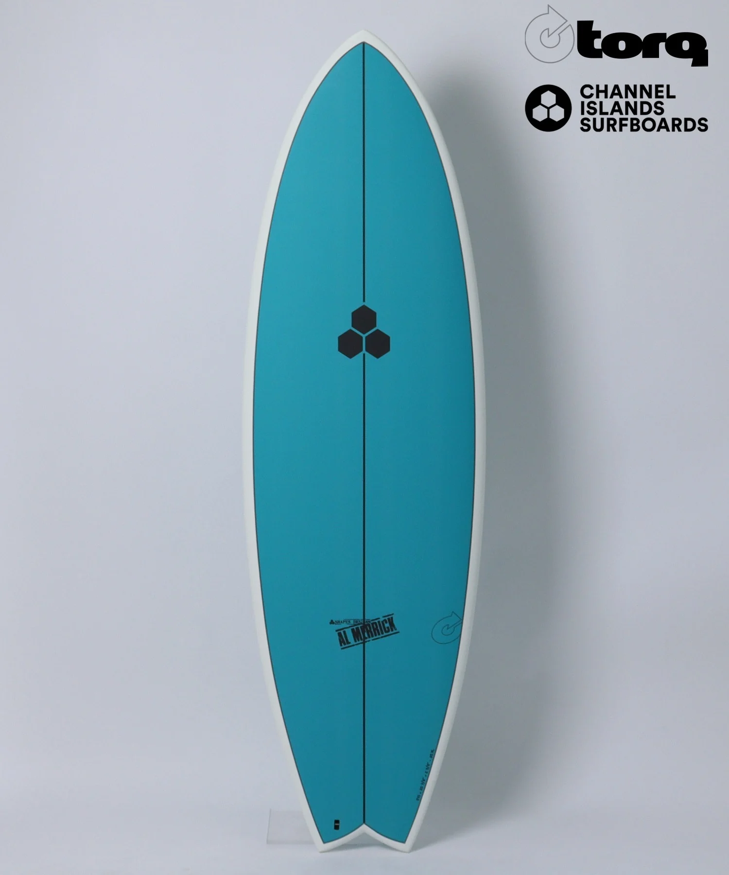 image - SHOP NEWS | ムラサキスポーツオンラインストア 通販 Turquoise surfboard standing upright with white edge, featuring black hexagon logo near center and logos on upper right corner: Torq and Channel Islands Surfboards (Al Merrick branding at bottom).
