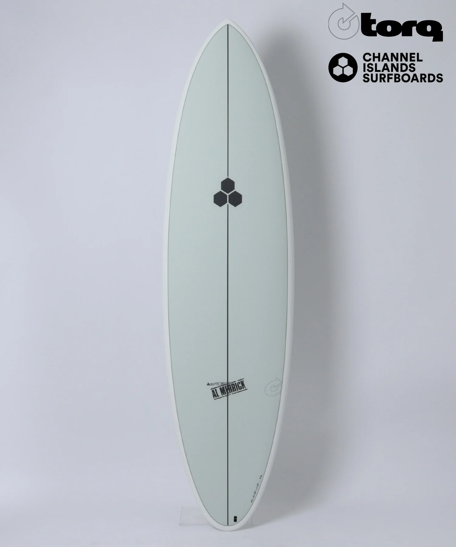 image - SHOP NEWS | ムラサキスポーツオンラインストア 通販 Pale gray surfboard standing upright against a white background with black hexagon logo midboard and brand logos in the top-right corner (Torq and Channel Islands Surfboards).