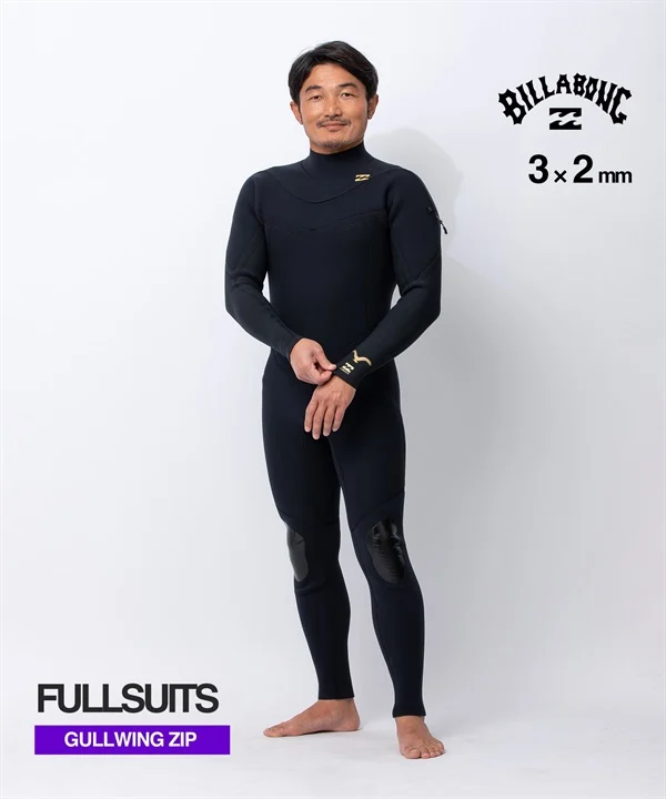 Male model wearing a black Billabong Gullwing Zip fullsuit (3x2mm) with knee pads, standing against a white studio background.